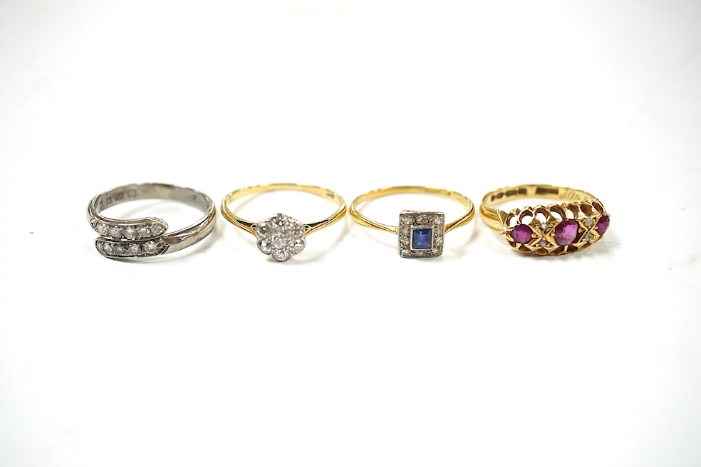 An 18ct and plat, sapphire and diamond set small cluster ring, size O, an 18ct and diamond set small cluster ring, an Edwardian 18ct gold, ruby and diamond set ring, a modern 18ct white gold and diamond set two row ring